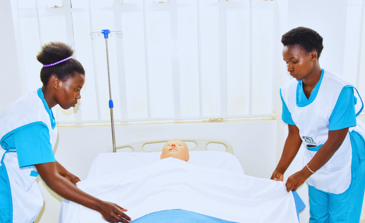 Students practising nursing procedures on a simulation patient